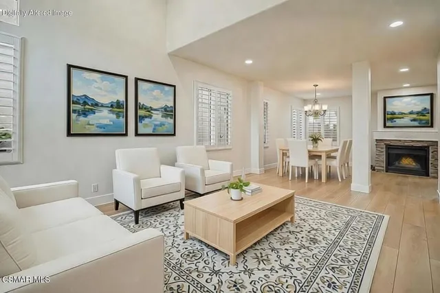 a living room with furniture a rug and a fireplace
