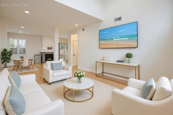 a living room with furniture and a potted plant