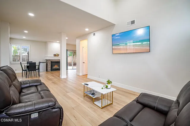 a living room with furniture and kitchen view