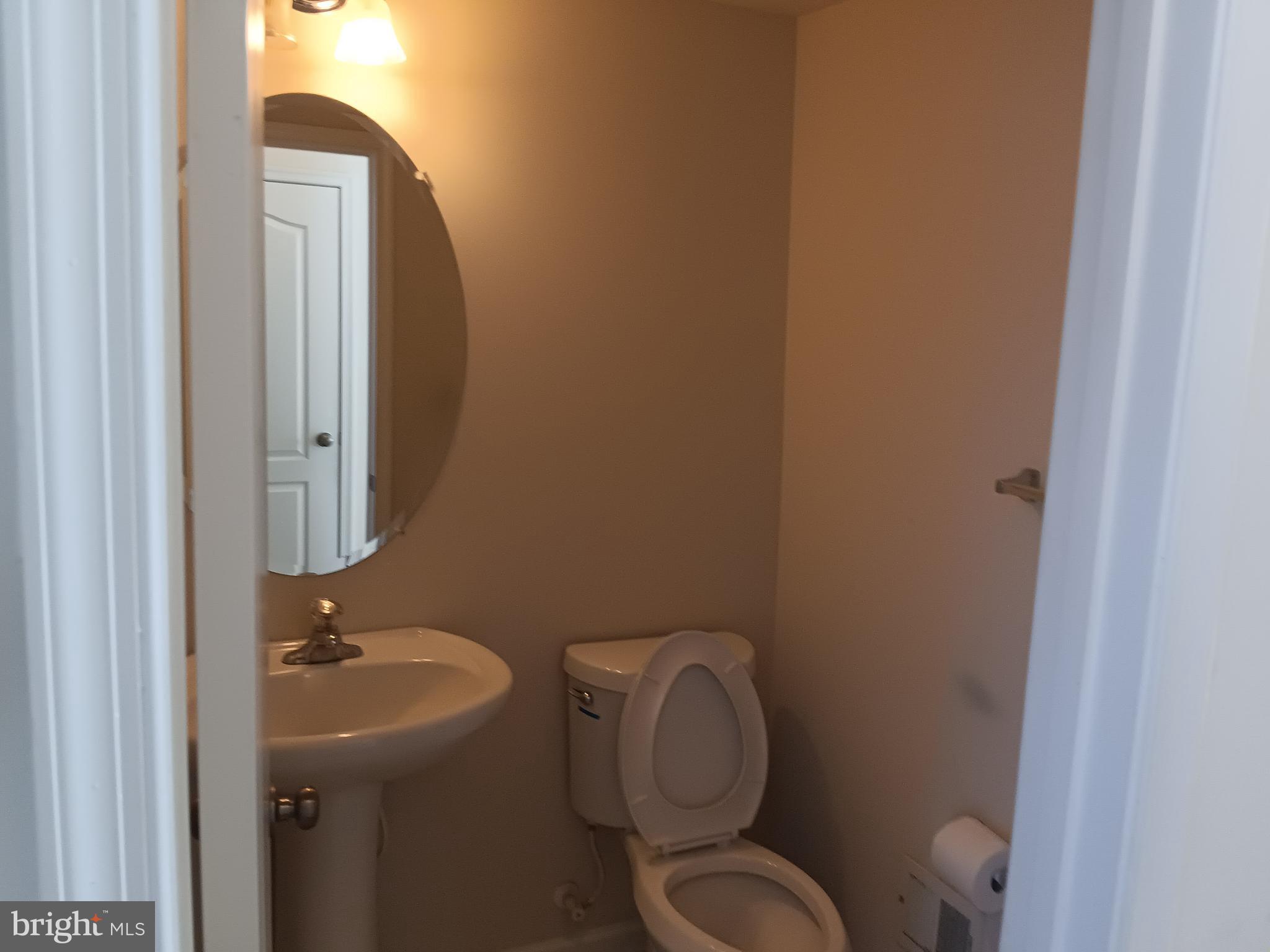9707 Risen Star Drive Upper Marlboro, MD 20772 - Photo 13 of 35 a bathroom with a toilet sink and mirror