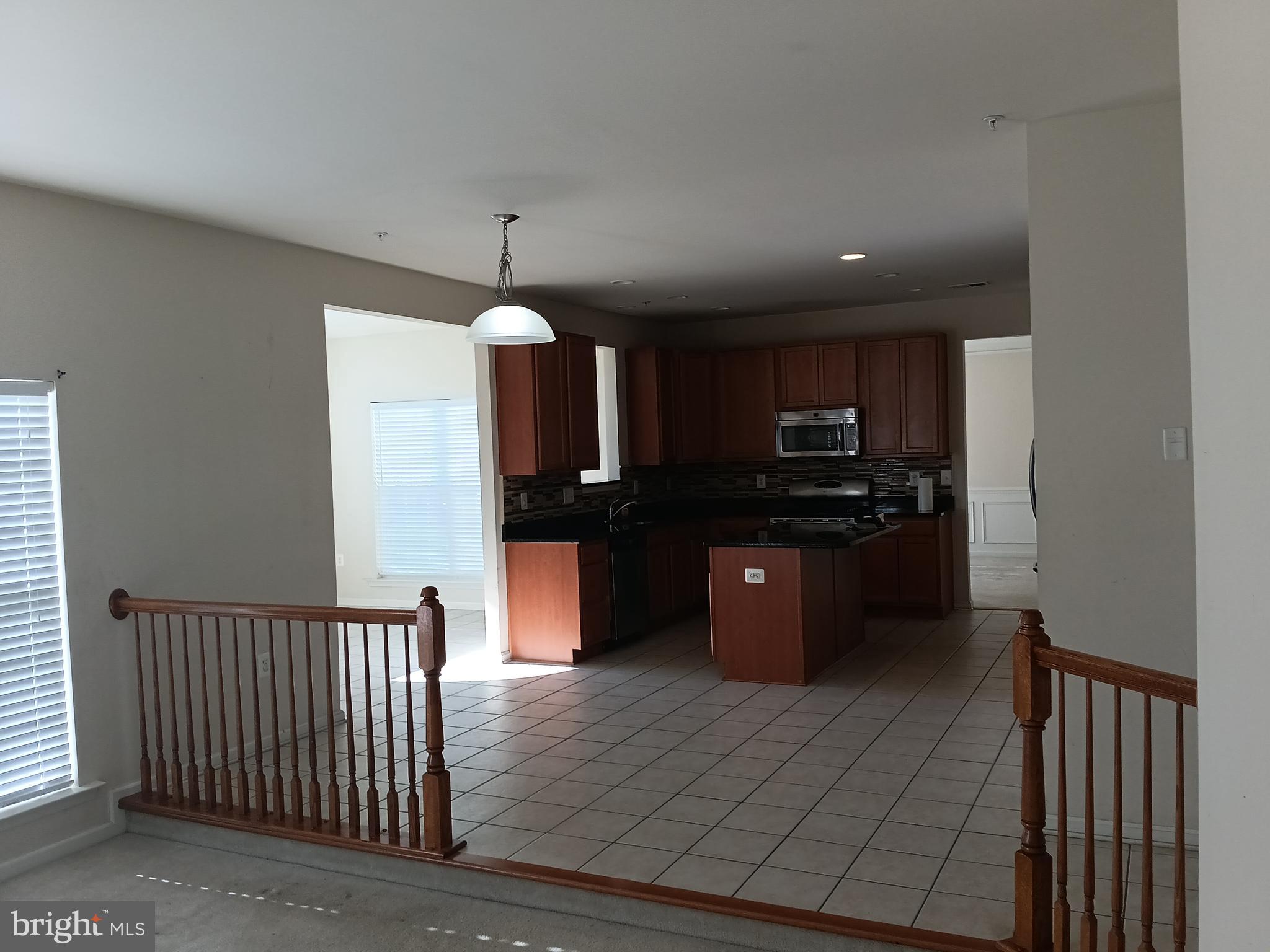 9707 Risen Star Drive Upper Marlboro, MD 20772 - Photo 16 of 35 a kitchen with stainless steel appliances kitchen island granite countertop a refrigerator and a stove top oven