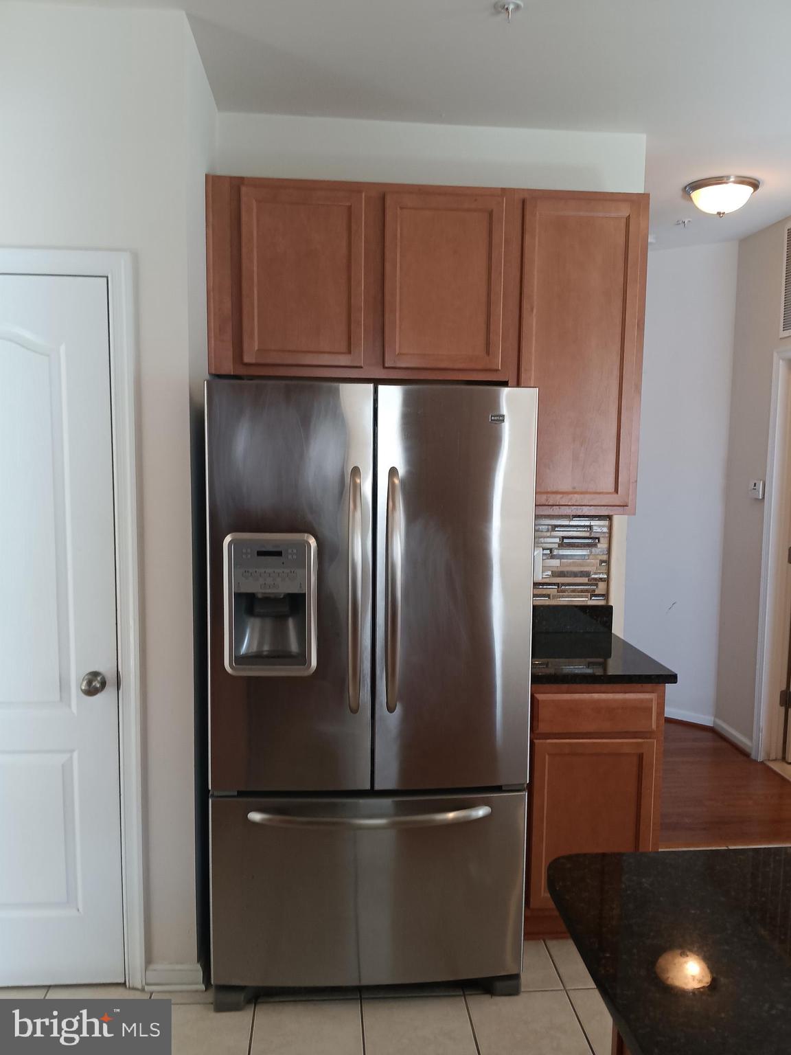 9707 Risen Star Drive Upper Marlboro, MD 20772 - Photo 20 of 35 a metallic refrigerator freezer sitting in a kitchen
