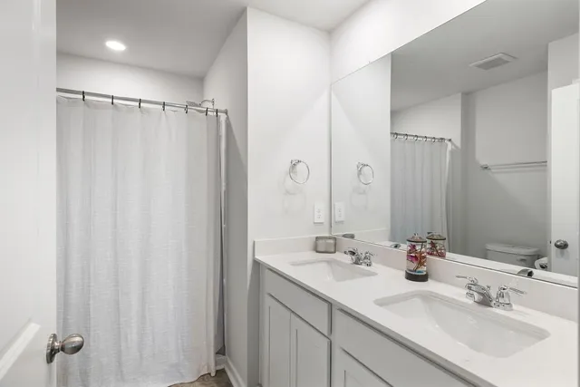 a bathroom with a double vanity sink and mirror