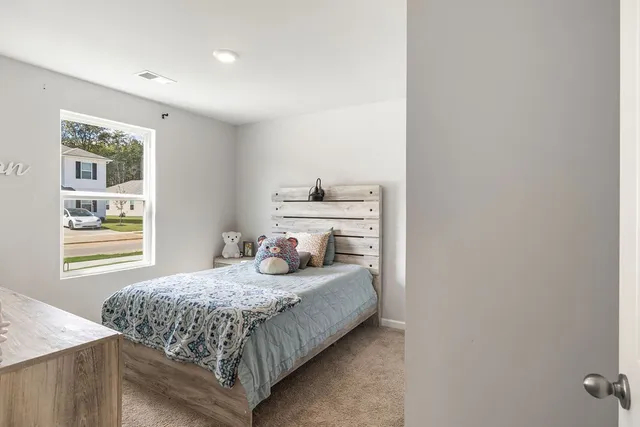a bedroom with a bed and window