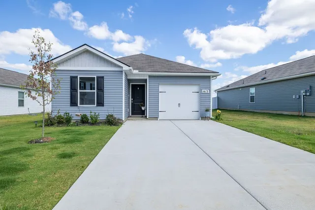 a view of a house with a yard
