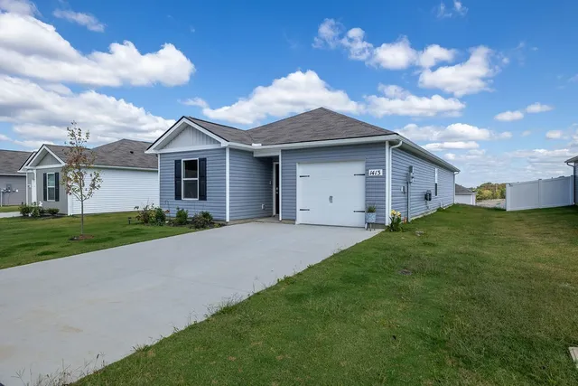 a front view of house with yard and green space