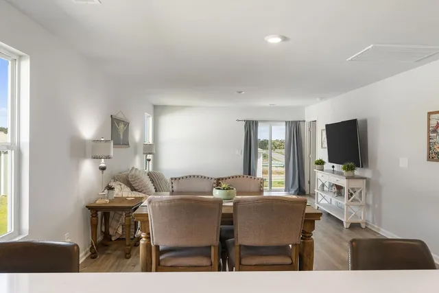 a view of a dining room with furniture window and wooden floor