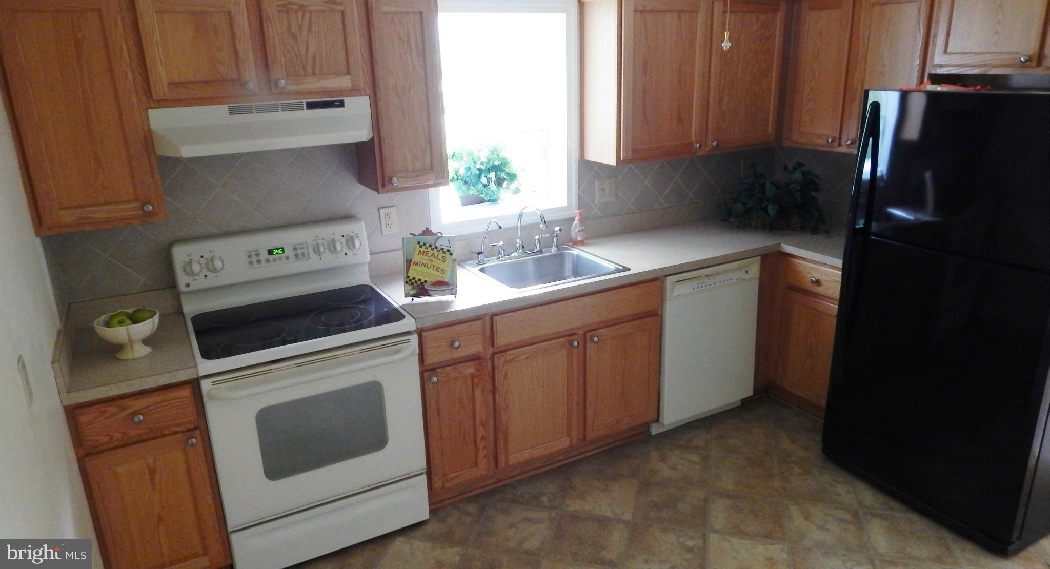 785 Evergreen Road Severn, MD 21144 - Photo 15 of 25 a kitchen with stainless steel appliances a stove a refrigerator and a sink