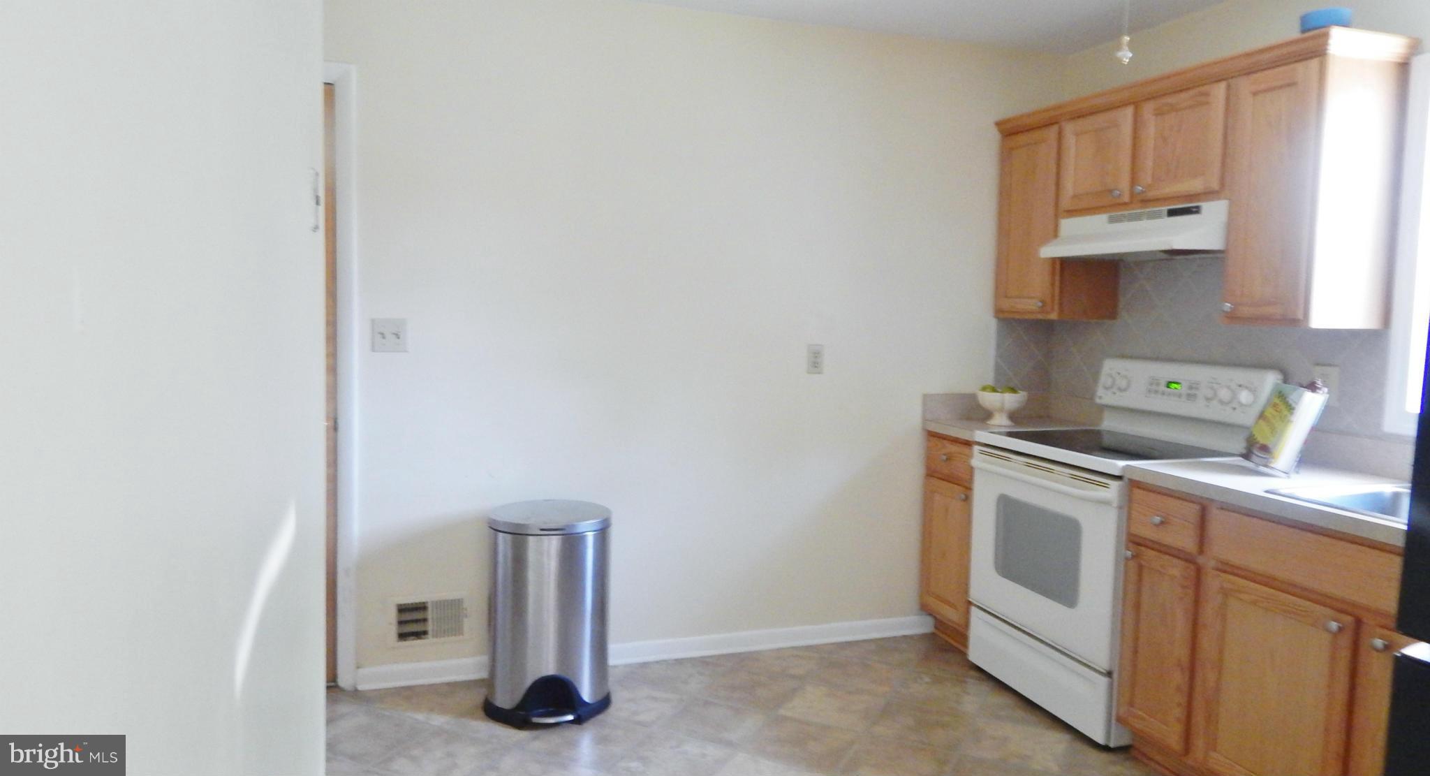 785 Evergreen Road Severn, MD 21144 - Photo 16 of 25 a kitchen with white cabinets and white appliances