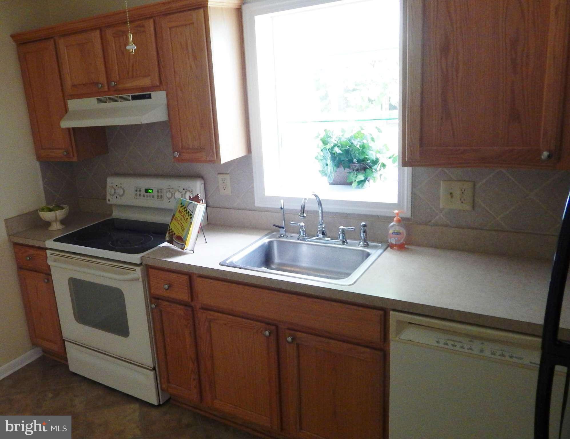 785 Evergreen Road Severn, MD 21144 - Photo 17 of 25 a kitchen with stainless steel appliances granite countertop a sink a stove and a microwave