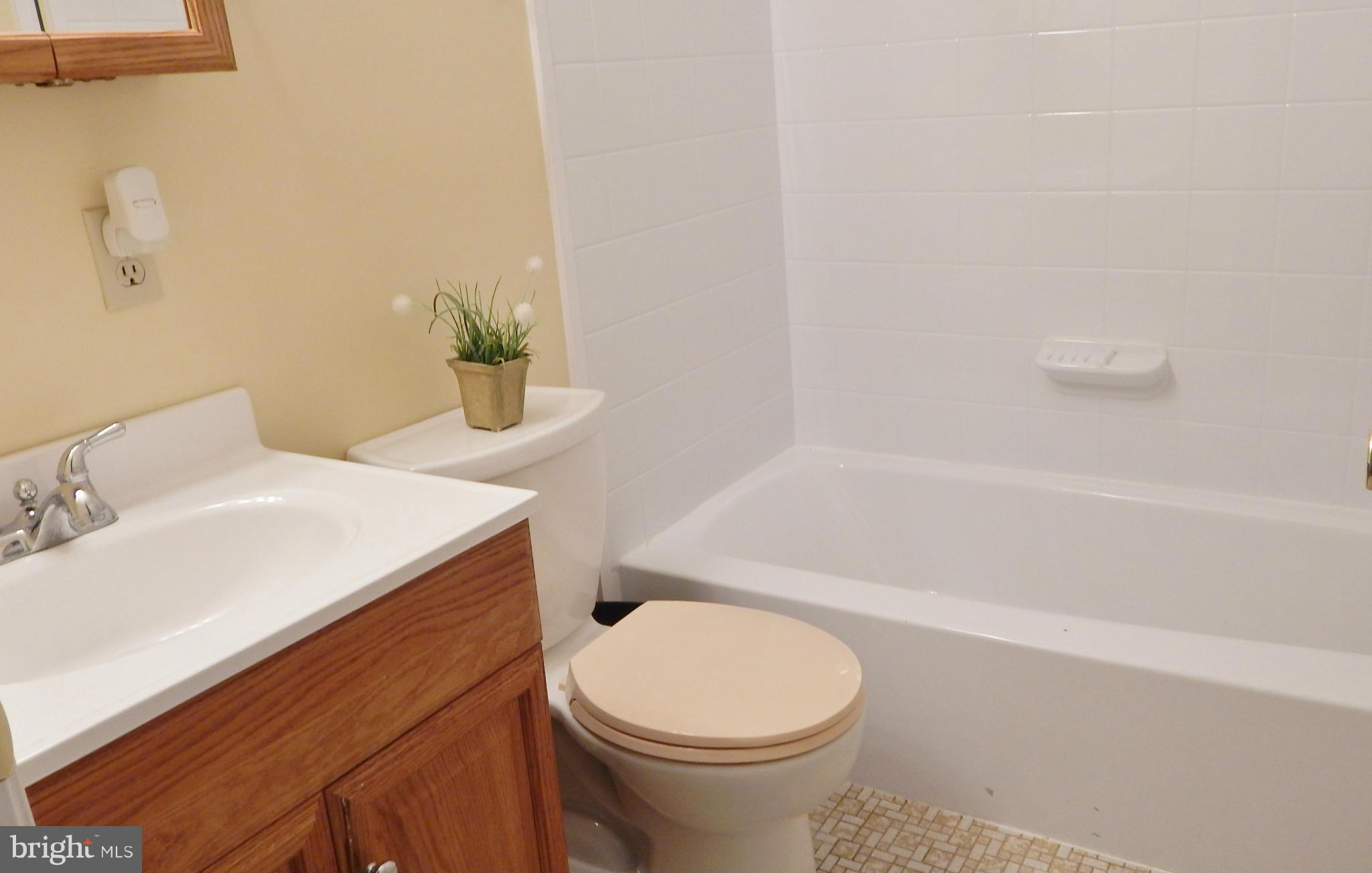 785 Evergreen Road Severn, MD 21144 - Photo 23 of 25 a bathroom with a sink a toilet and tub