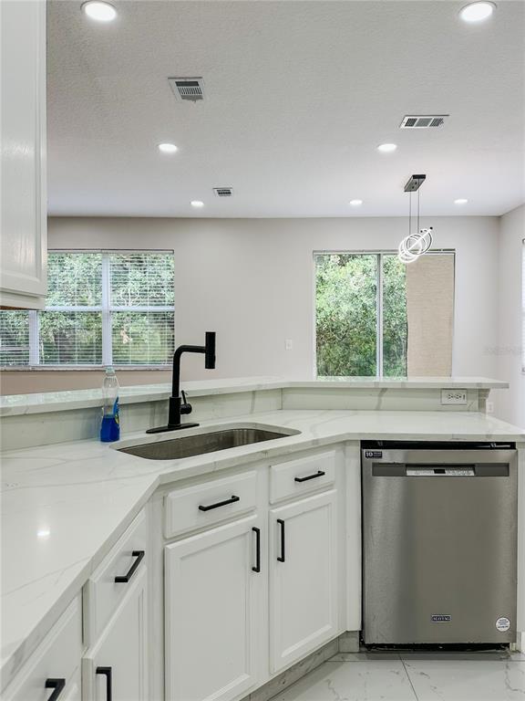 7322 Bridgeview Drive Wesley Chapel, FL 33545 - Photo 19 of 75 a kitchen with a sink and window