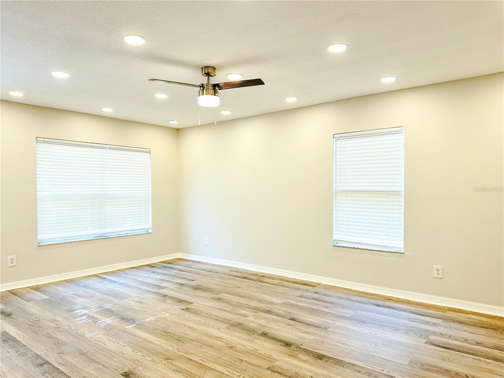 7322 Bridgeview Drive Wesley Chapel, FL 33545 - Photo 29 of 75 an empty room with wooden floor and windows