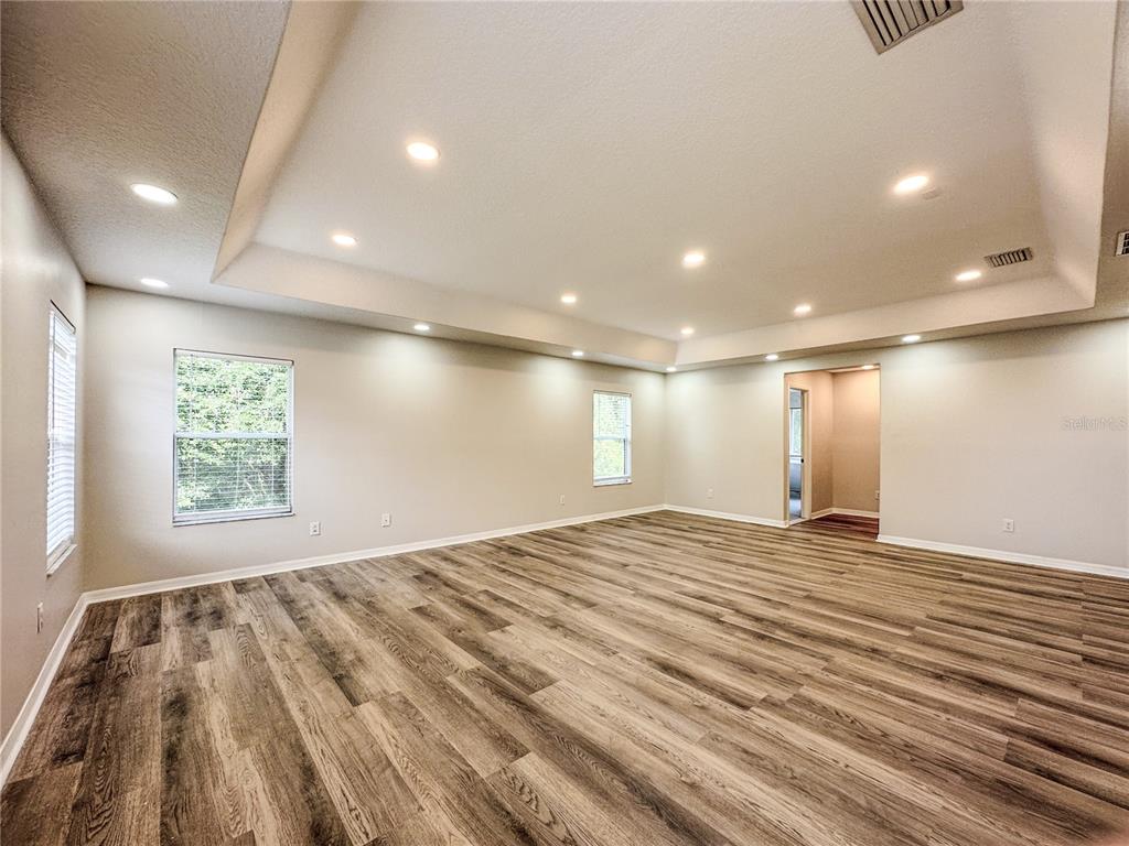 7322 Bridgeview Drive Wesley Chapel, FL 33545 - Photo 30 of 75 a view of an empty room with wooden floor and a window