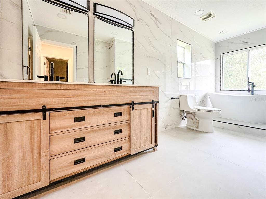 7322 Bridgeview Drive Wesley Chapel, FL 33545 - Photo 32 of 75 a bathroom with a sink vanity and mirror