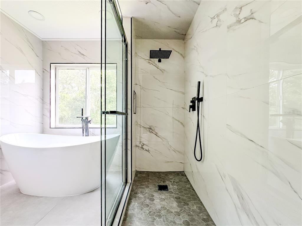 7322 Bridgeview Drive Wesley Chapel, FL 33545 - Photo 34 of 75 a bathroom with a bathtub and a shower