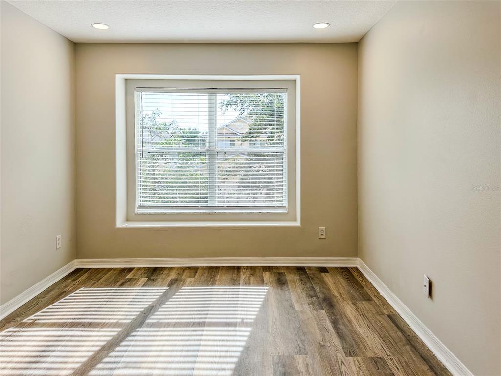 7322 Bridgeview Drive Wesley Chapel, FL 33545 - Photo 44 of 75 a view of a room with wooden floor and window