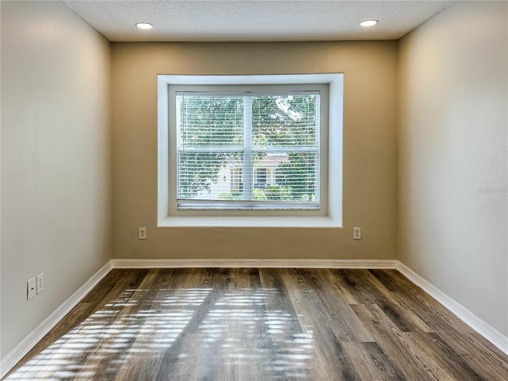 7322 Bridgeview Drive Wesley Chapel, FL 33545 - Photo 46 of 75 a view of a room with wooden floor and a window