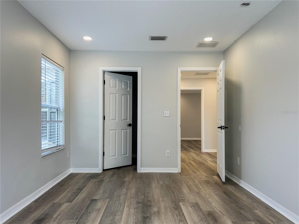 7322 Bridgeview Drive Wesley Chapel, FL 33545 - Photo 47 of 75 an empty room with wooden floor and windows