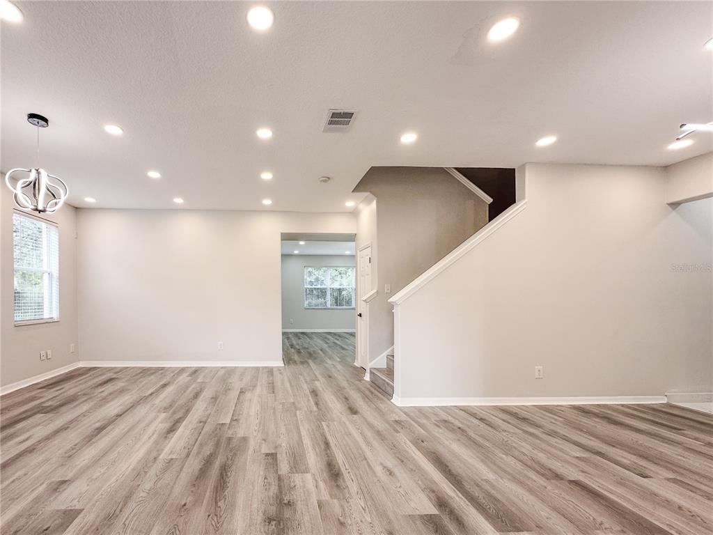 7322 Bridgeview Drive Wesley Chapel, FL 33545 - Photo 5 of 75 a view of empty room with wooden floor
