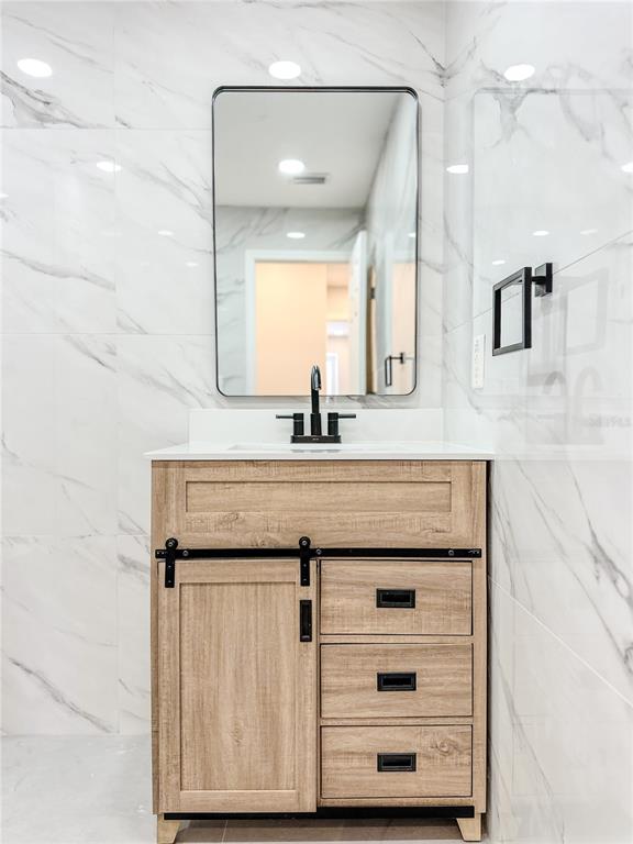 7322 Bridgeview Drive Wesley Chapel, FL 33545 - Photo 52 of 75 a bathroom with a sink vanity granite and a mirror