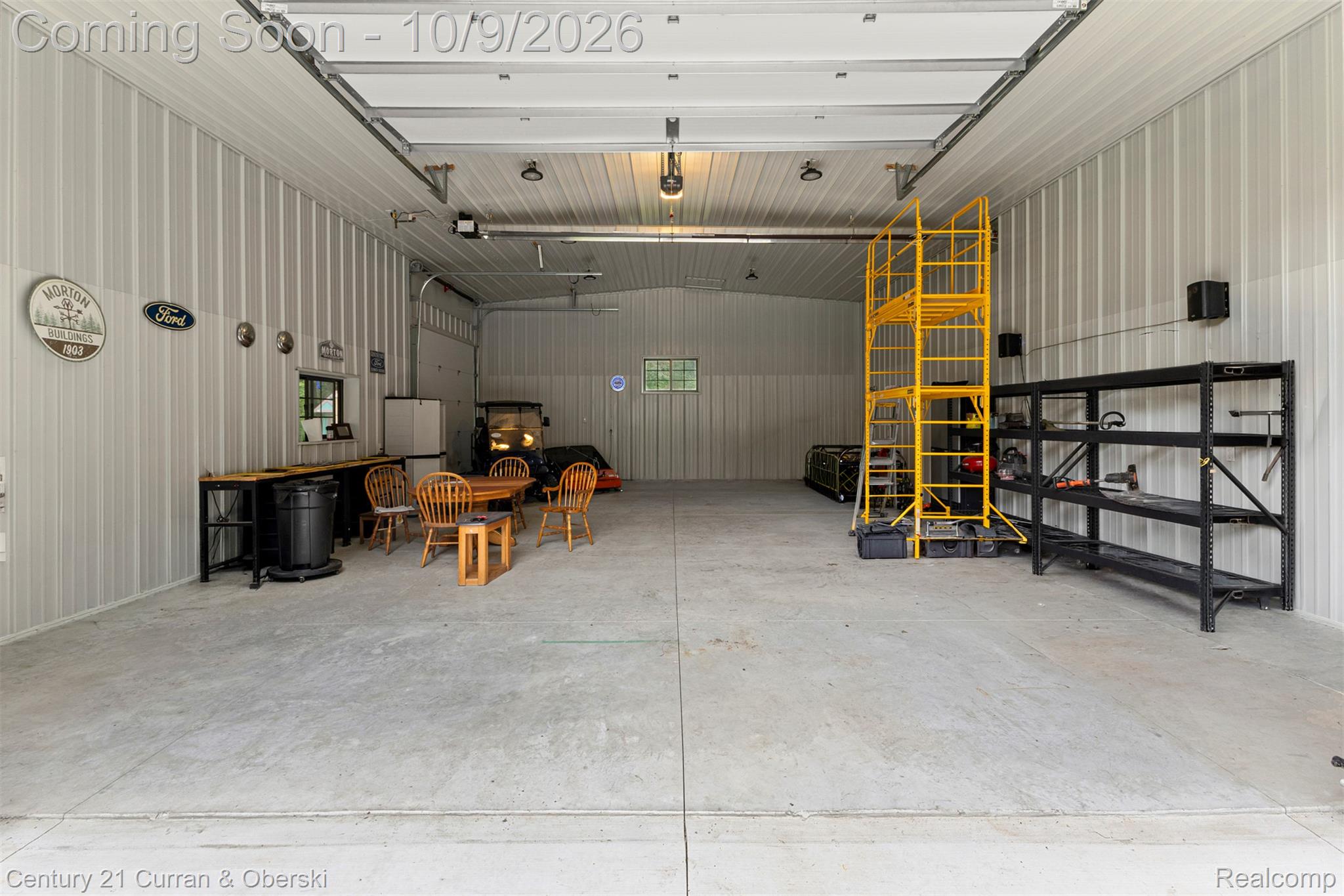 43040 Willis Road Belleville, MI 48111 - Photo 42 of 65 Spacious utility building with corrugated metal walls, exposed overhead garage door tracks, and durable concrete flooring