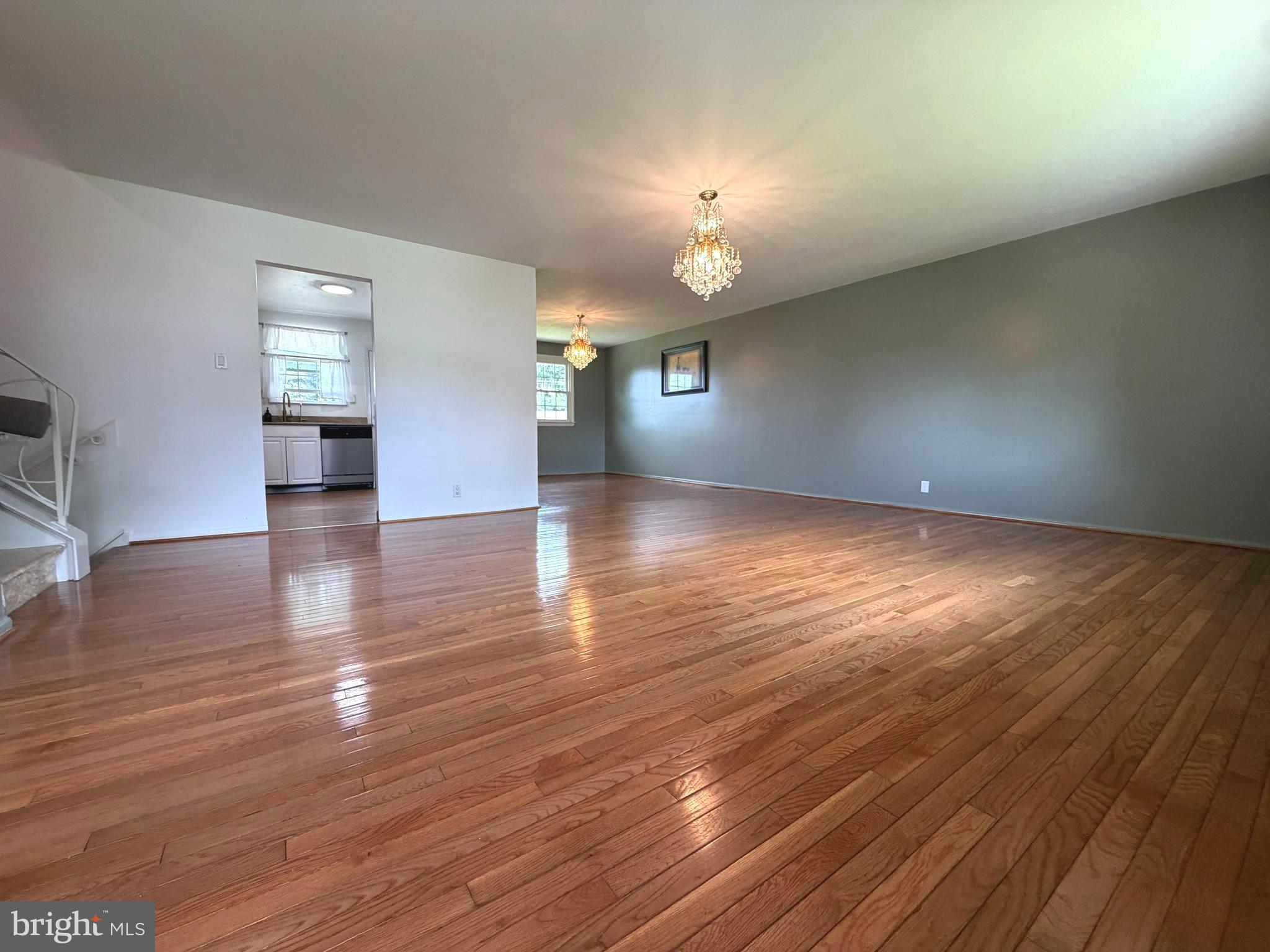 1207 Greenhill Road Flourtown, PA 19031 - Photo 2 of 9 an empty room with wooden floor and windows