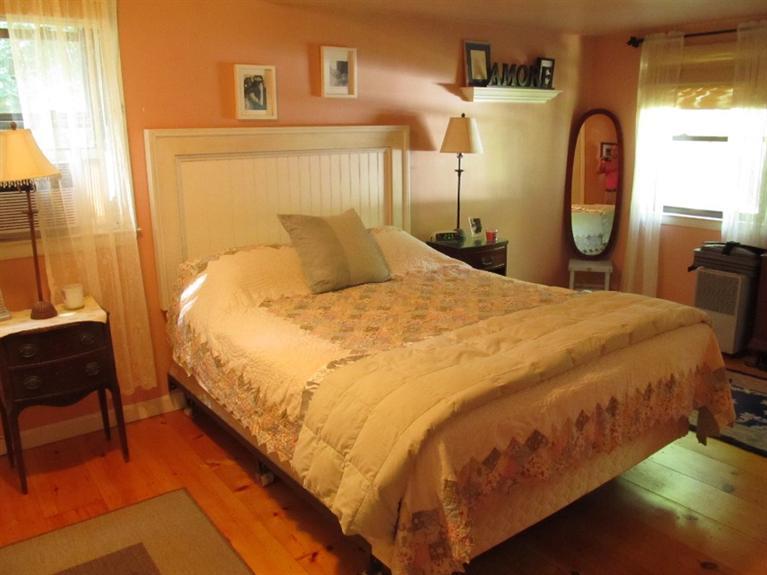 150 Pimlico Pond Road Mashpee, MA 02649 - Photo 13 of 26 a large bed sitting in a bedroom next to a window