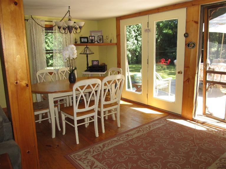 150 Pimlico Pond Road Mashpee, MA 02649 - Photo 14 of 26 a dining room with furniture a chandelier and wooden floor