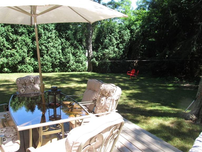 150 Pimlico Pond Road Mashpee, MA 02649 - Photo 17 of 26 a view of a table and chairs under an umbrella