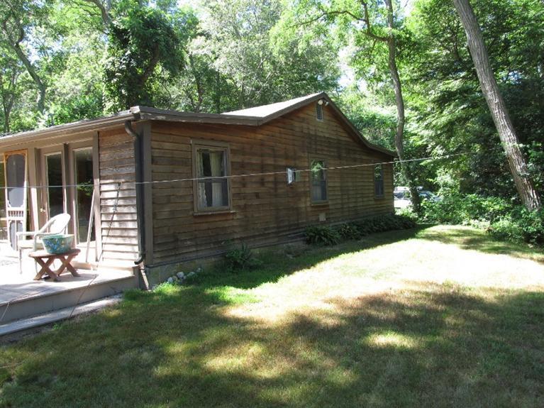 150 Pimlico Pond Road Mashpee, MA 02649 - Photo 24 of 26 a backyard of a house with lots of green space