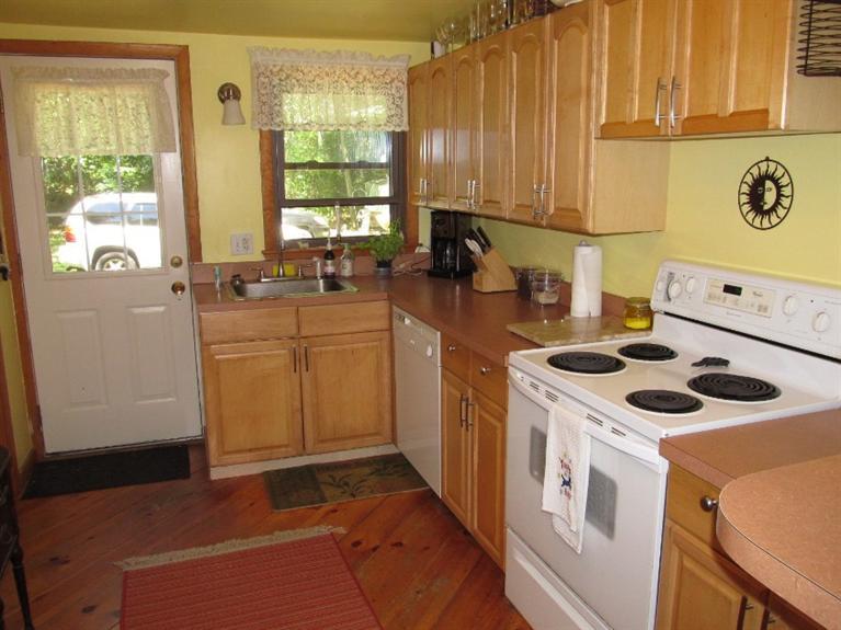 150 Pimlico Pond Road Mashpee, MA 02649 - Photo 9 of 26 a kitchen with a stove a sink and a refrigerator