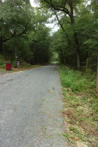 a backyard of a house with lots of green space and lake view