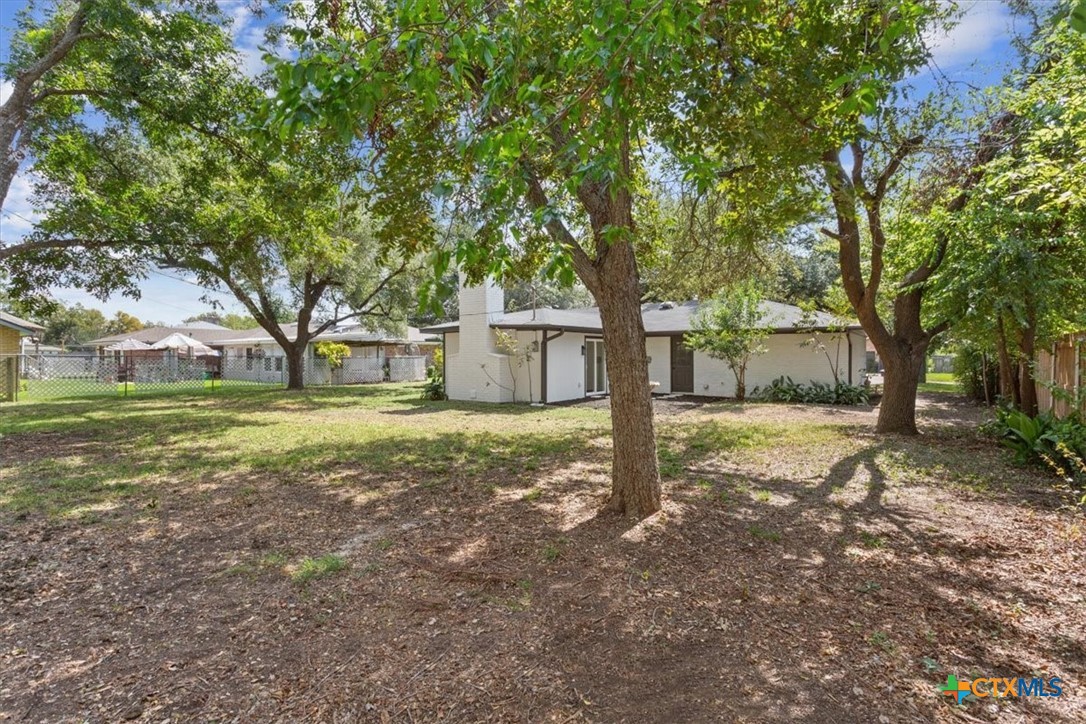 4412 Briar Cliff Road Temple, TX 76502 - Photo 25 of 28 a view of a house with backyard and tree