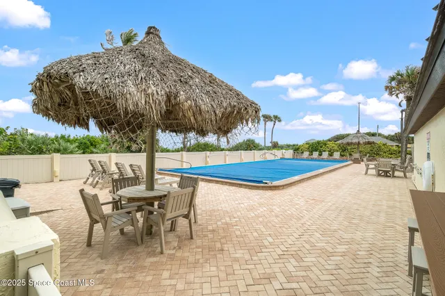 a view of a backyard with sitting area
