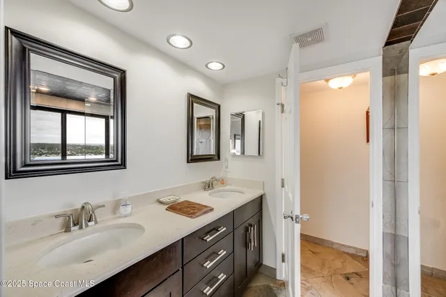 a living room with a bed furniture and a chandelier