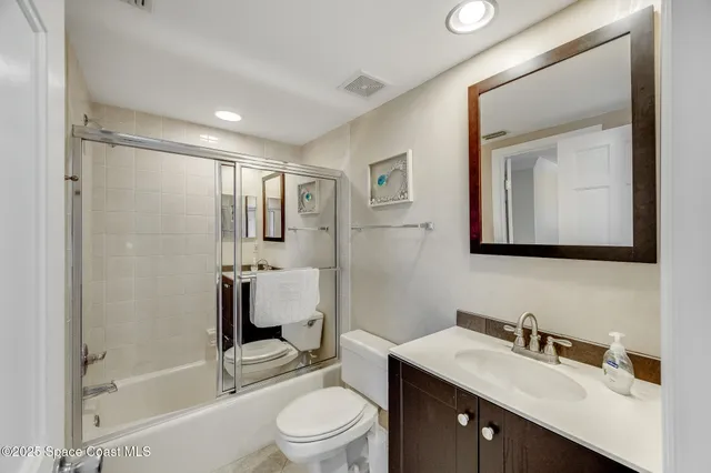 a dining room with furniture large windows and wooden floor