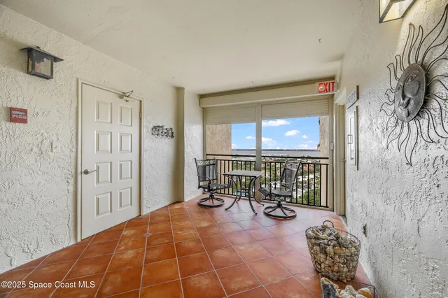 a view of a balcony with a table and chairs