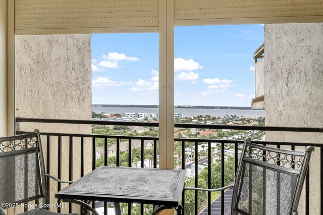 a view of a dining room with furniture and a chandelier