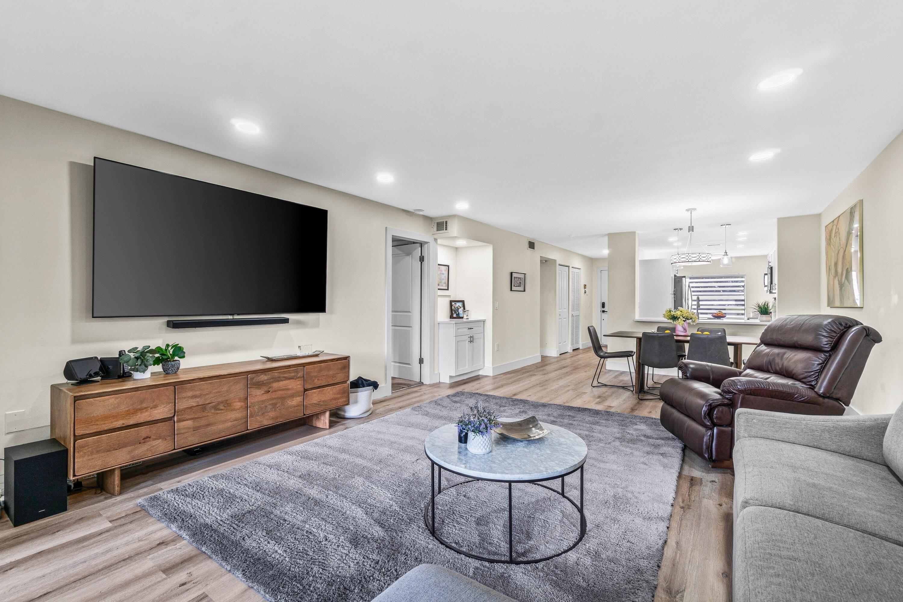 18 Stratford Drive, Unit E Boynton Beach, FL 33436 - Photo 10 of 49 a living room with furniture and a flat screen tv