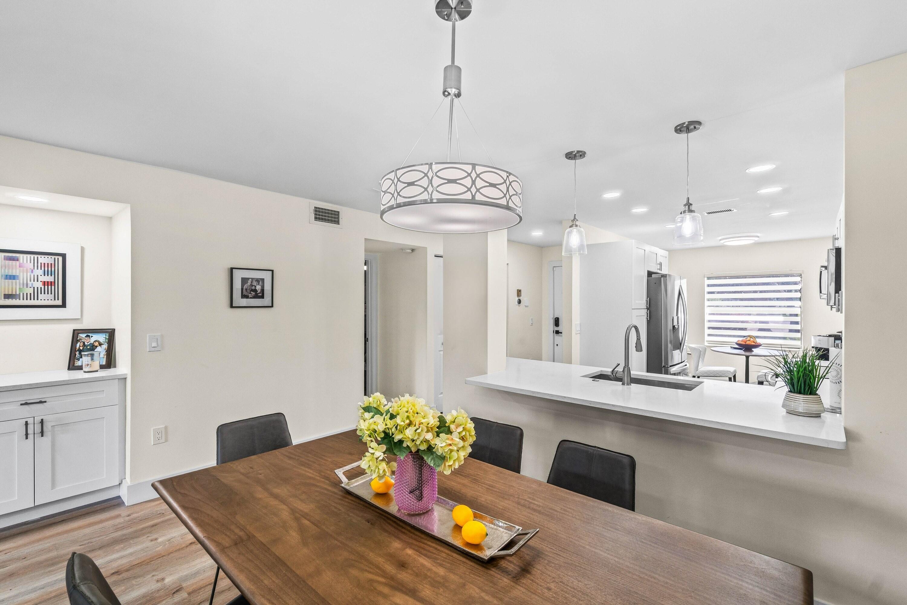 18 Stratford Drive, Unit E Boynton Beach, FL 33436 - Photo 11 of 49 a living room with furniture and a chandelier
