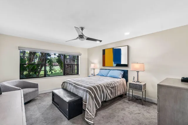 a bathroom with a granite countertop toilet sink shower and mirror