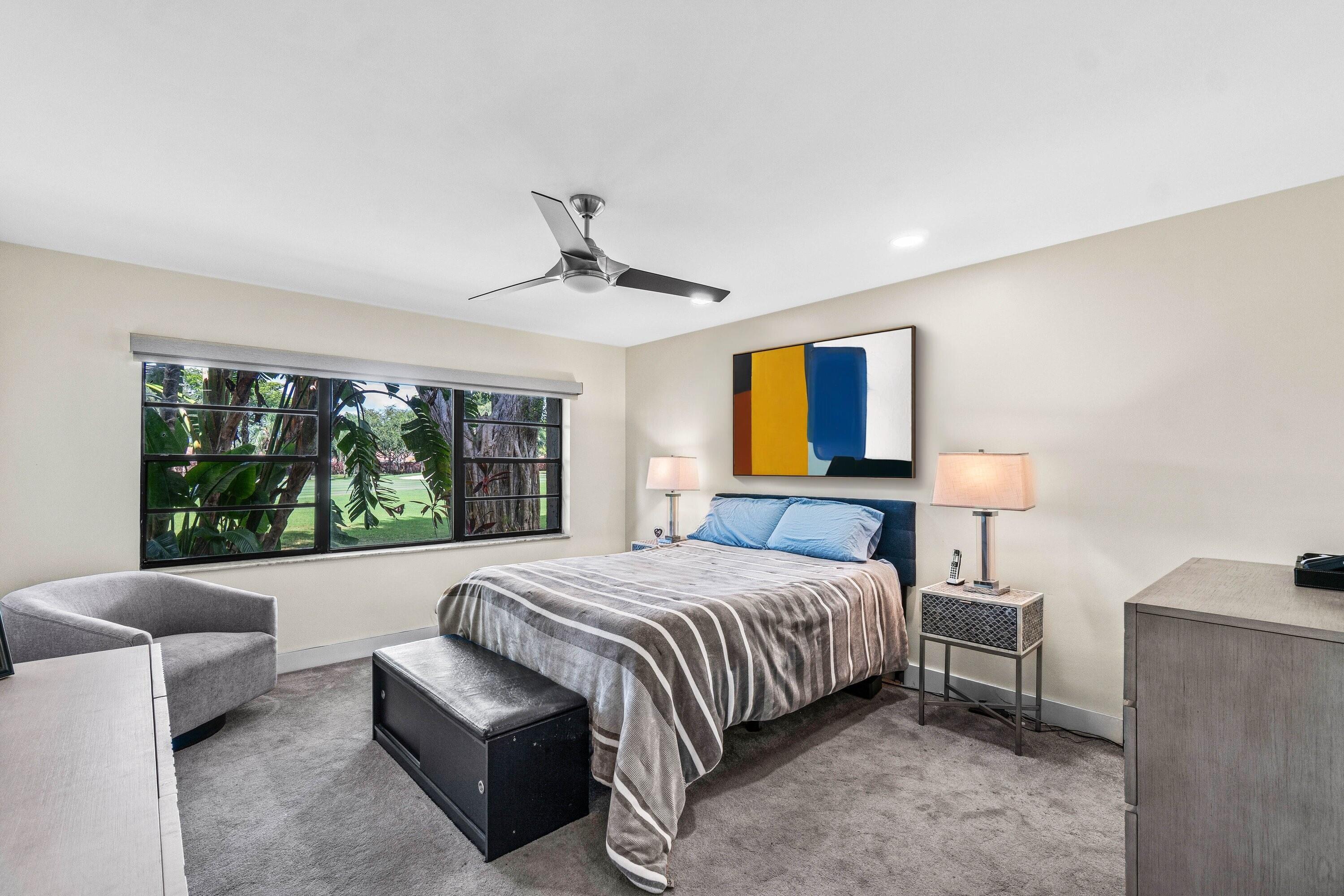 18 Stratford Drive, Unit E Boynton Beach, FL 33436 - Photo 14 of 49 a bedroom with a large bed and a couch