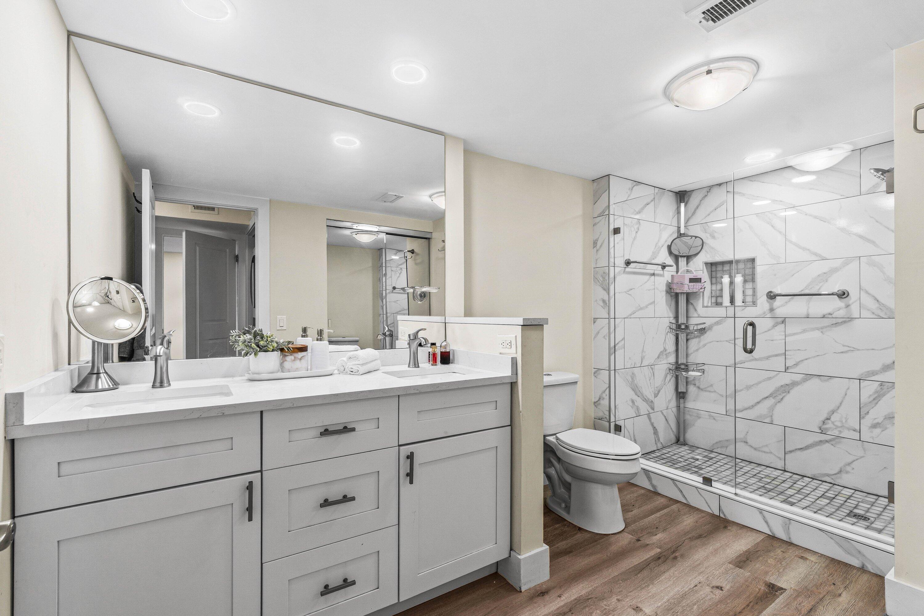 18 Stratford Drive, Unit E Boynton Beach, FL 33436 - Photo 15 of 49 a bathroom with a double vanity sink toilet and shower