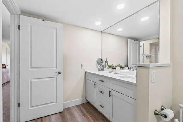 a bathroom with a double vanity sink toilet and shower