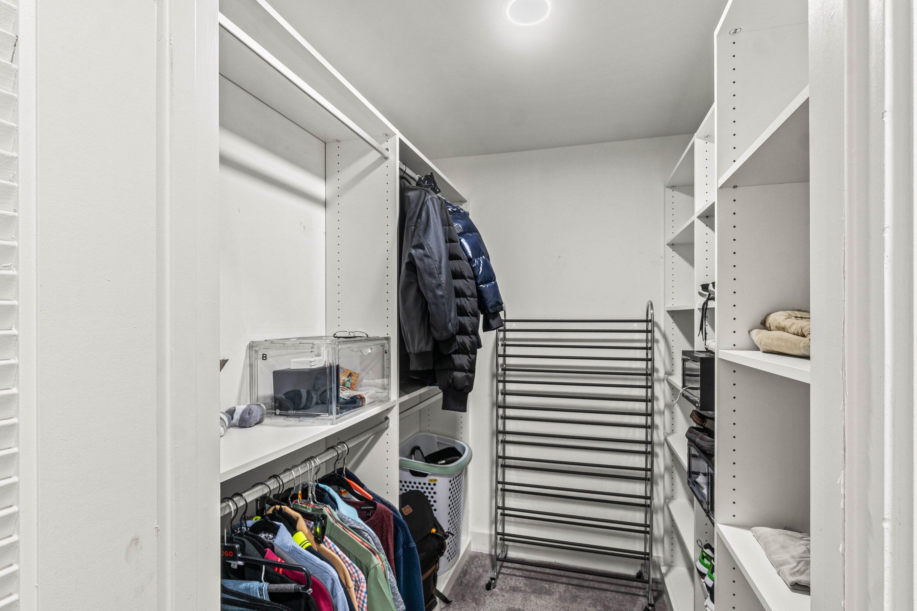 18 Stratford Drive, Unit E Boynton Beach, FL 33436 - Photo 17 of 49 a view of walk in closet with clothes and shoes