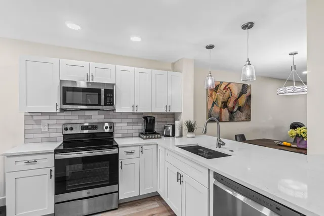 a open kitchen with sink cabinets and wooden floor