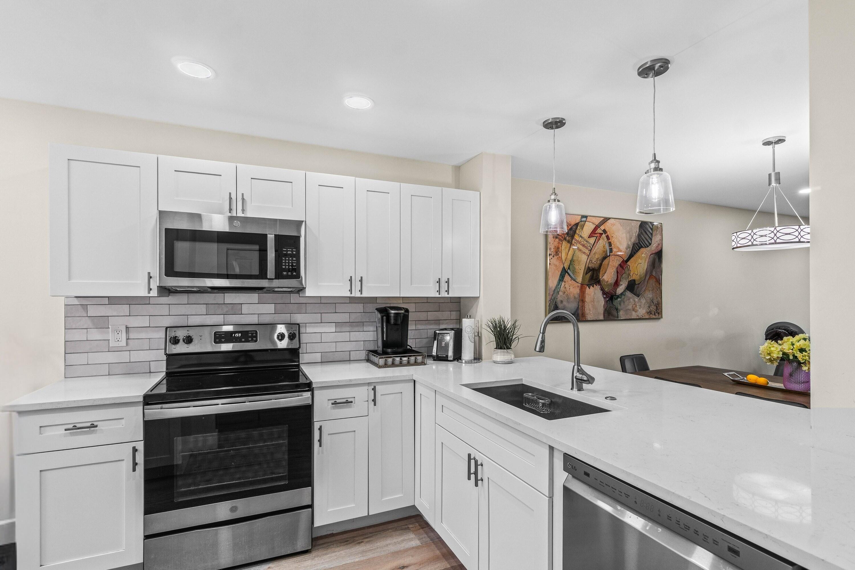 a kitchen with a sink a stove and microwave