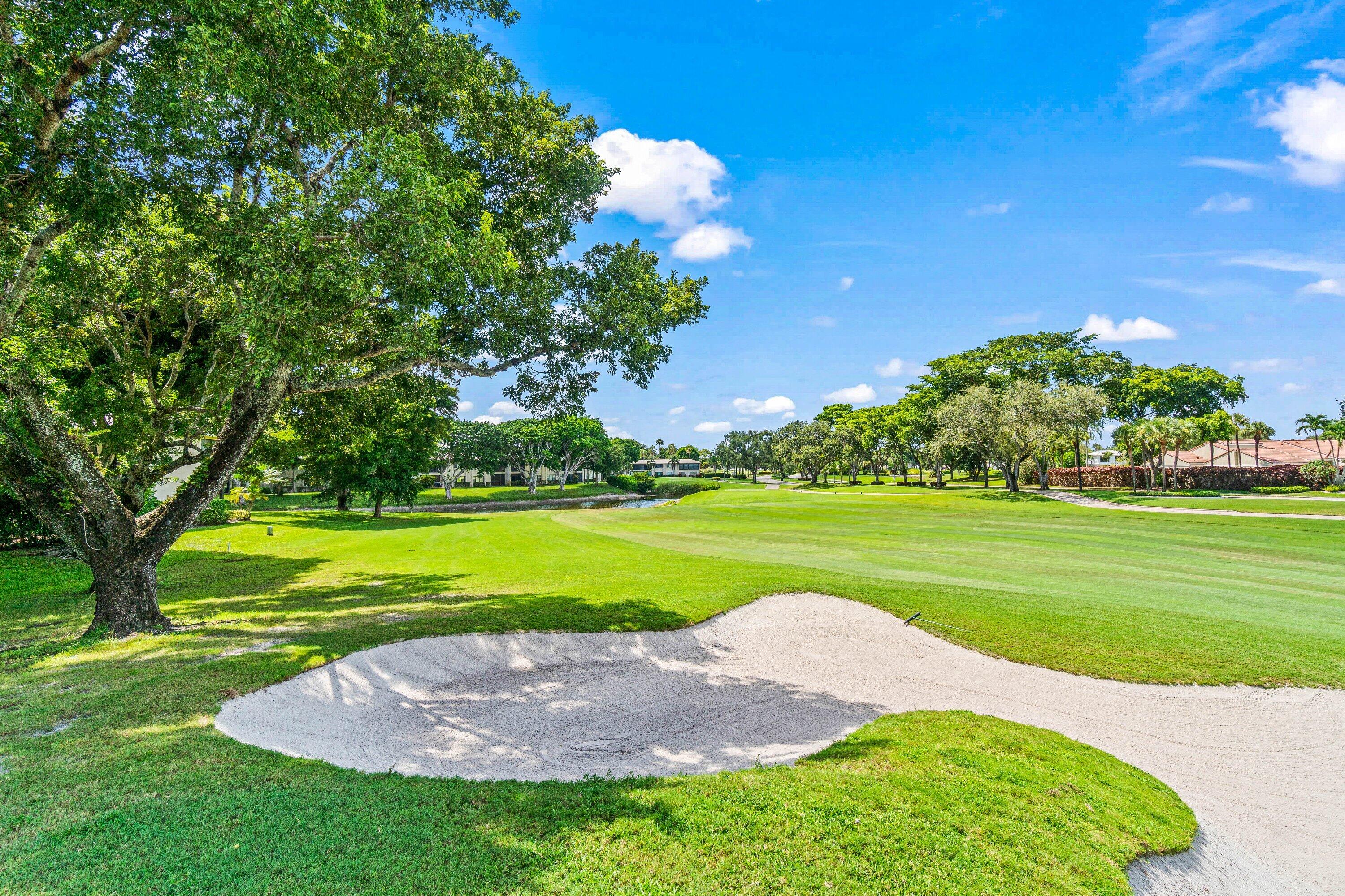 18 Stratford Drive, Unit E Boynton Beach, FL 33436 - Photo 24 of 49 a view of a golf course with a lake view