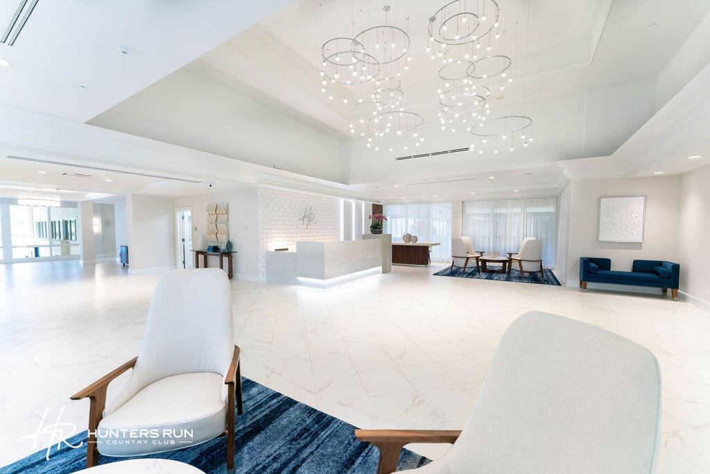 18 Stratford Drive, Unit E Boynton Beach, FL 33436 - Photo 37 of 49 a living room with furniture and a chandelier